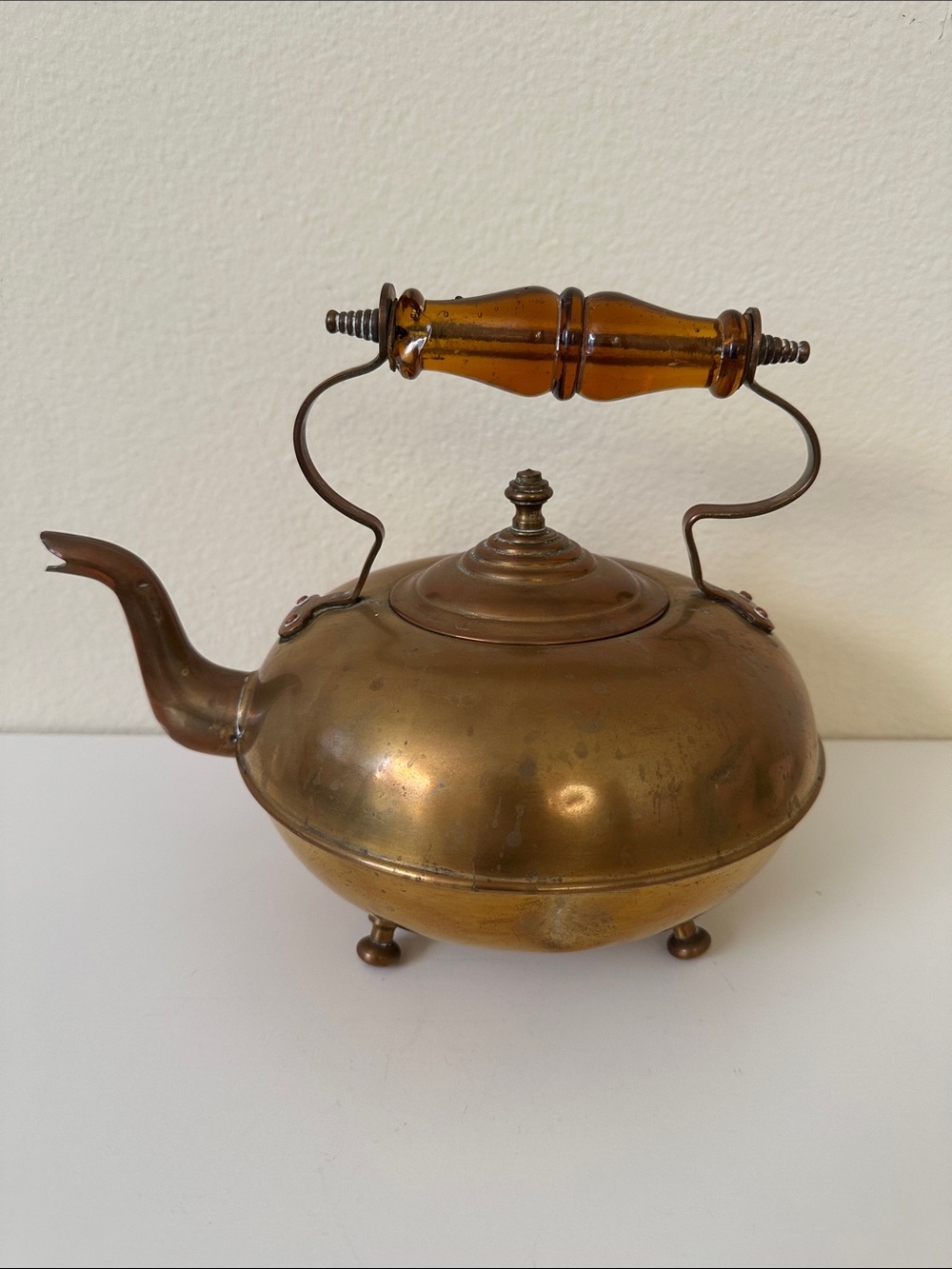 Antique-Inspired Brass Footed Tea Kettle with Amber Glass Handle